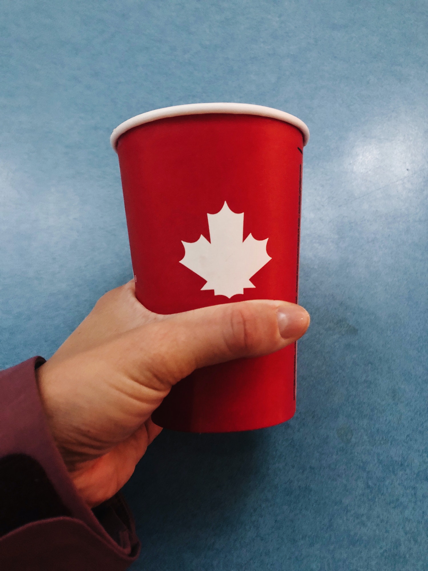 And holding red cup with Canadian flag