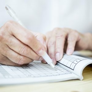 Close-up of senior woman doing a crossword puzzle