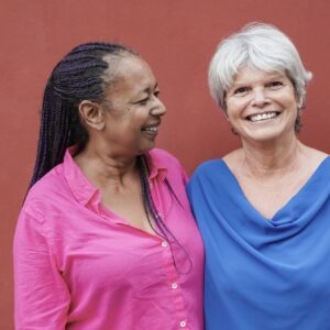 Multiracial female friends - Elderly women hugging together outdoor
