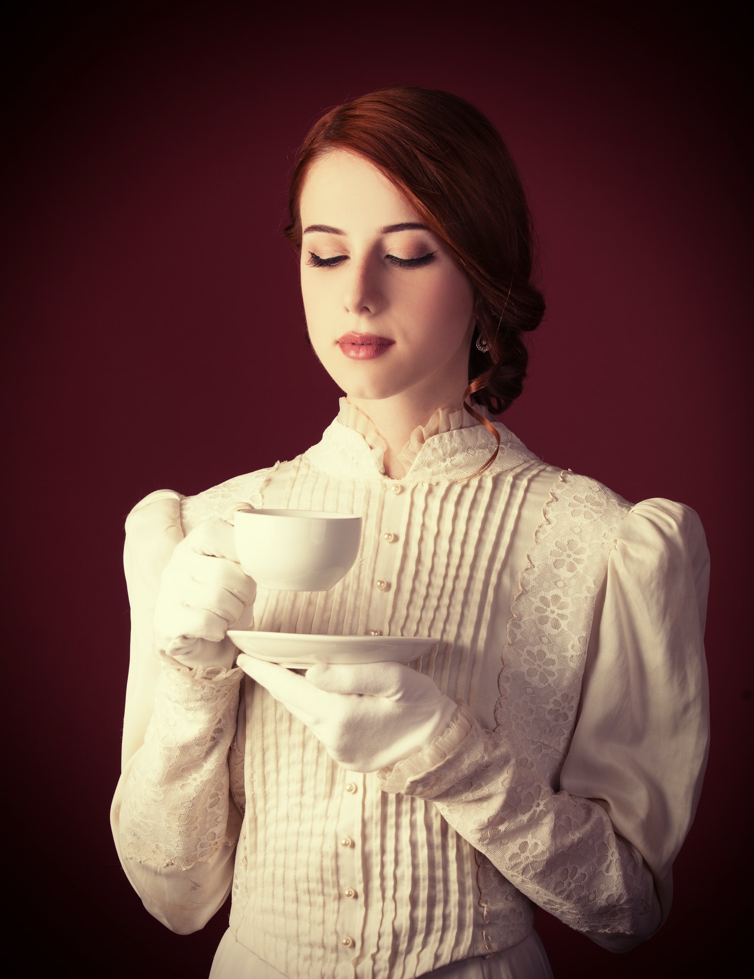 Beautiful redhead women with cup of tea