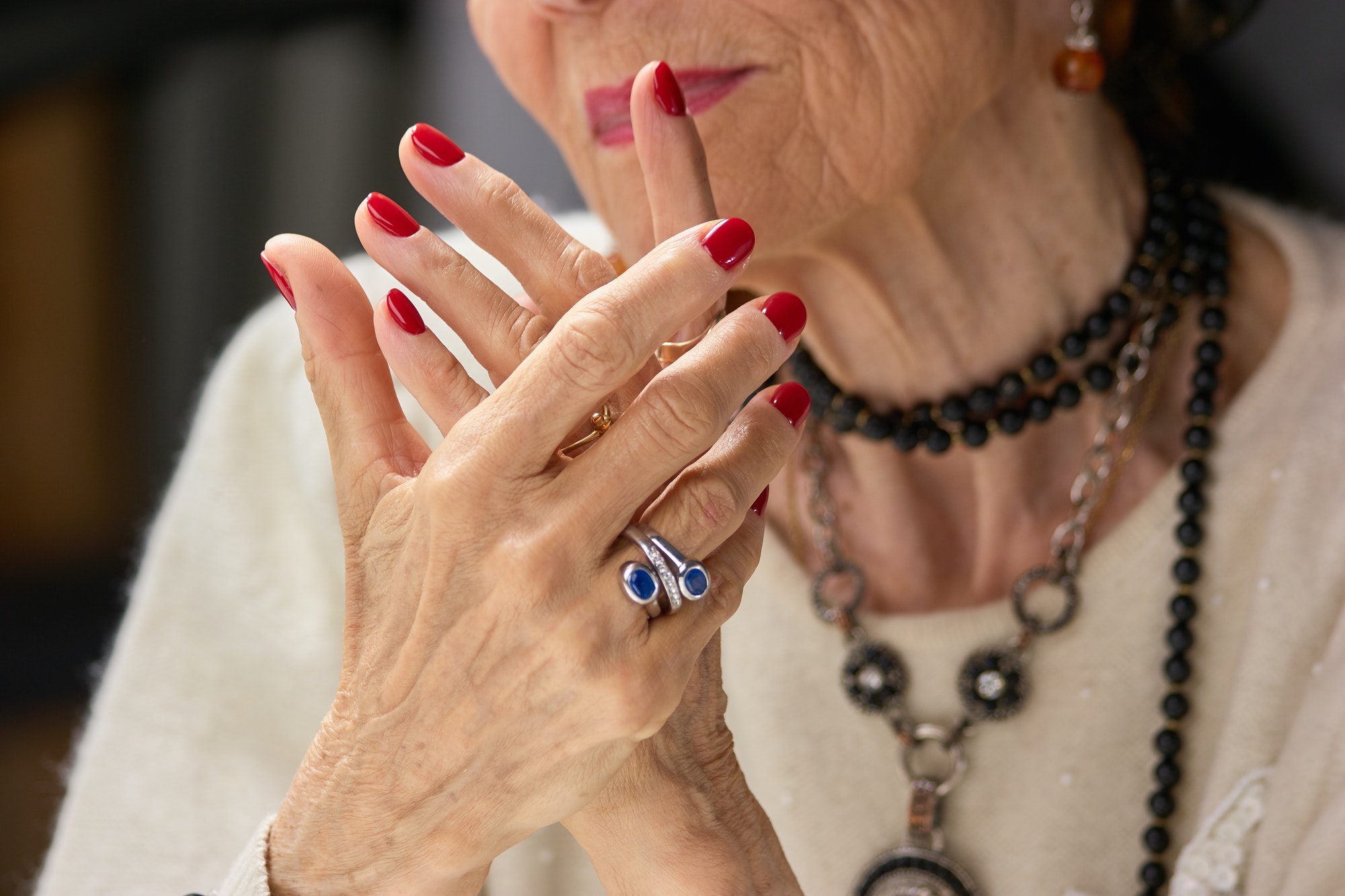 Old womans manicured hands with ring