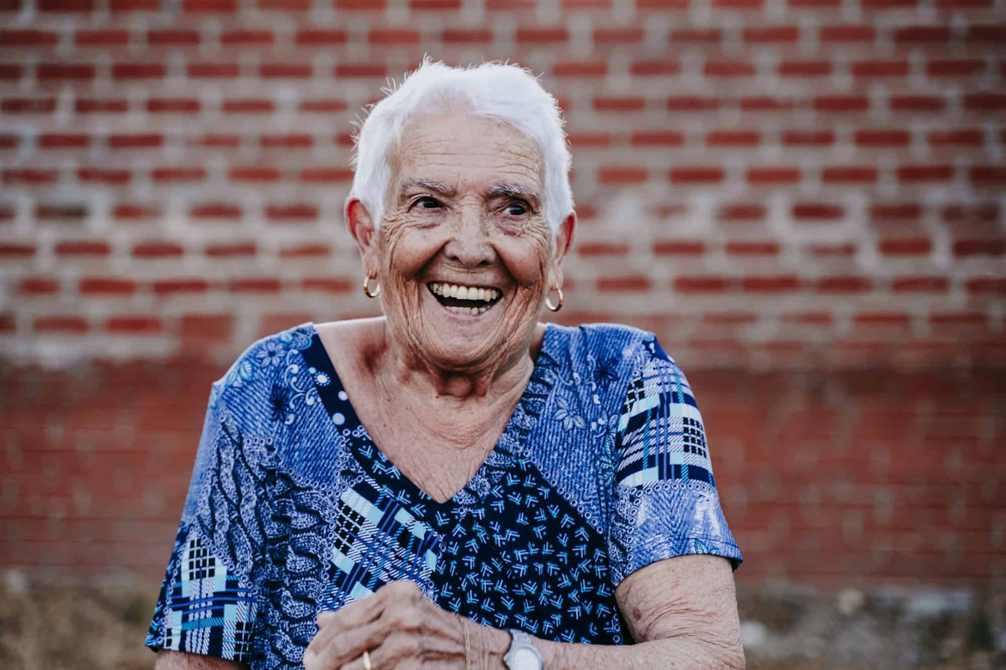 portrait of old lady in her 80s laughing happily