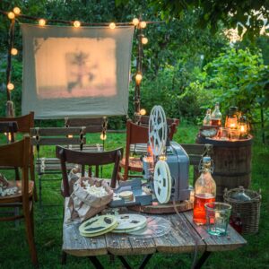 Cozy summer cinema with vintage projector in the evening