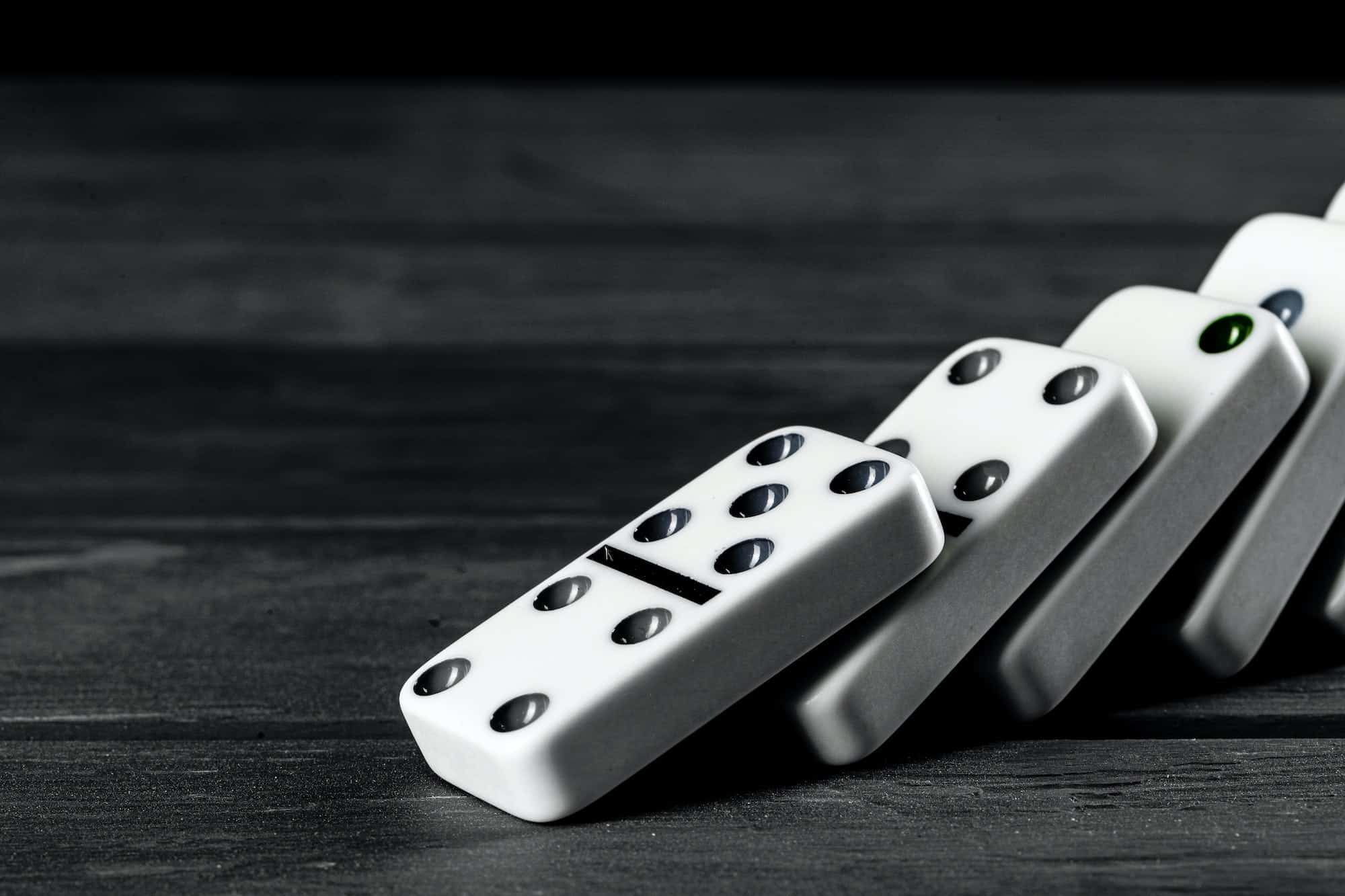 Domino game. Dominoes on a black table