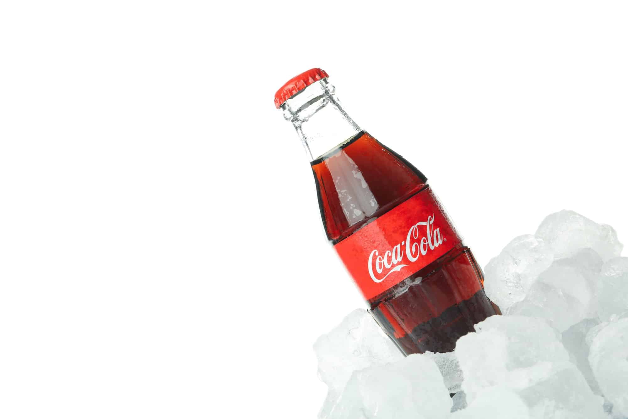Odessa, Ukraine - 20 January, 2022. Coca-cola bottle in ice isolated on white background